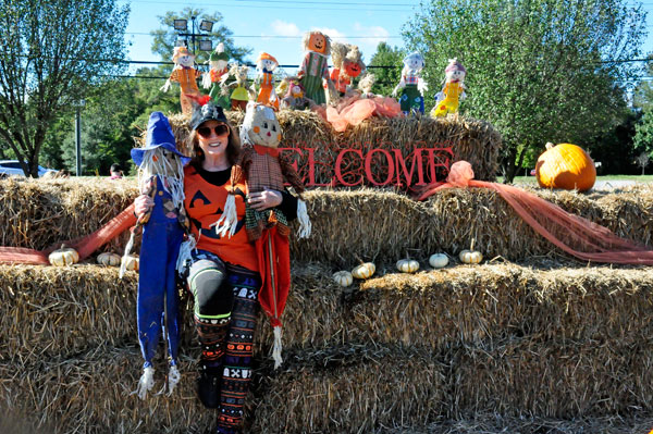 Karen Duquette and the scarecrows at the hay bales